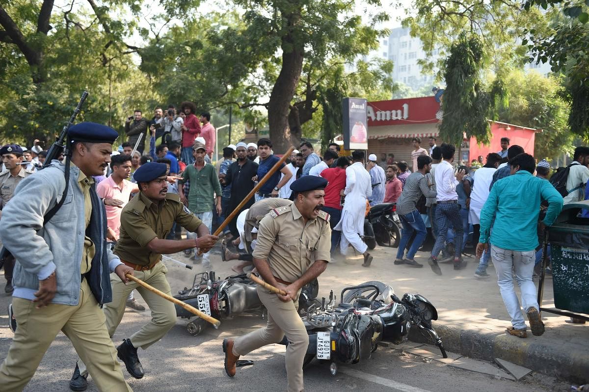 Gujarat police react to disperse protesters during a demonstration against India's new citizenship law in Ahmedabad (Photo by AFP)