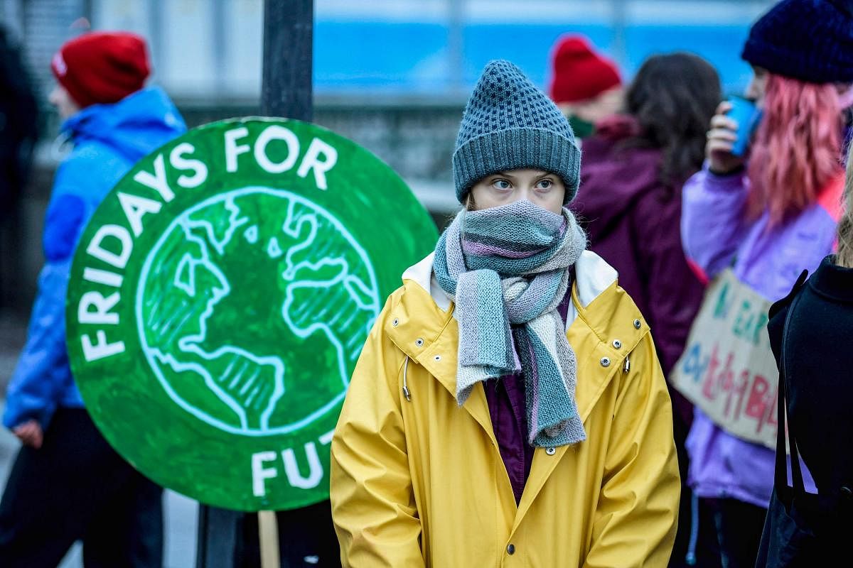 Swedish environmental activist Greta Thunberg attends a climate strike arrangd by the orgatisation "Fridays For Future" outside the Swedish parliament Riksdagen in Stockholm, December 20, 2019. (Photo by AFP)