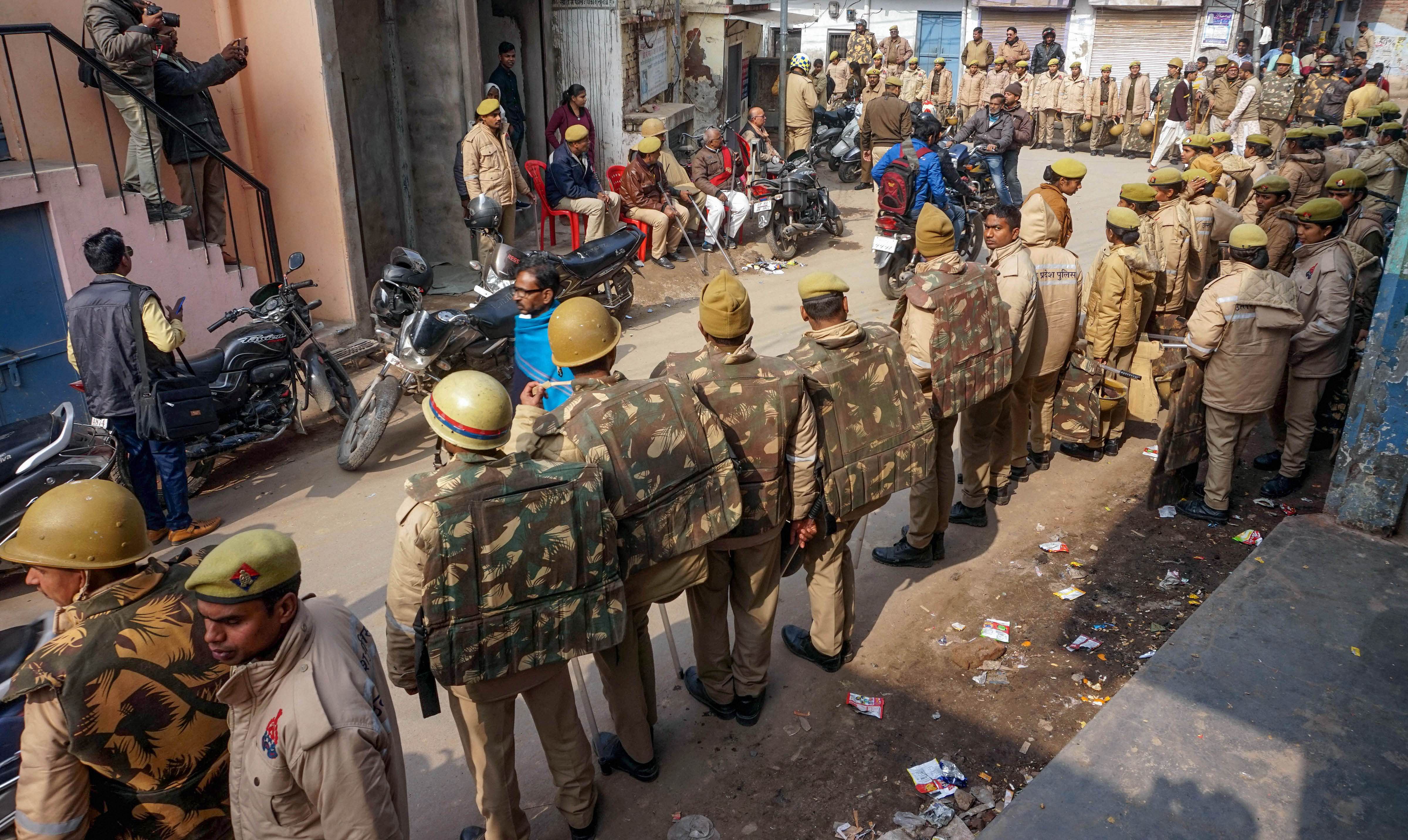  Police personnel guard a street during protests against Citizenship Amendment Act (CAA) in Varanasi. (PTI Photo)