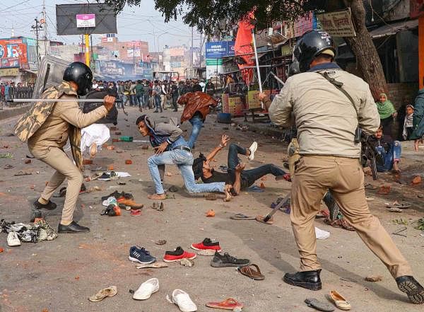 Police personnel baton charge at protestors during their rally against NRC and amended Citizenship Act that turned violent, in Lucknow, Thursday, Dec. 19, 2019. (PTI Photo)