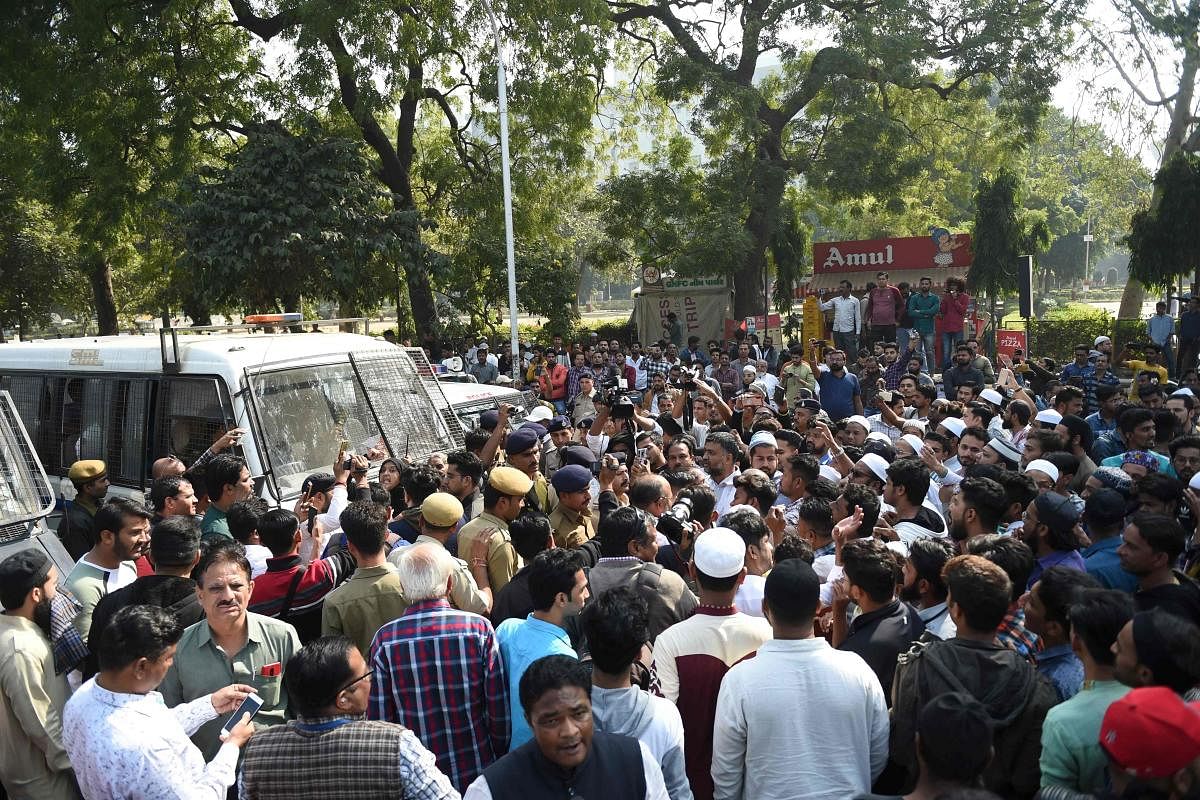 Protesters stop a police vehicle with detainees inside during a demonstration against India's new citizenship law in Ahmedabad. AFP