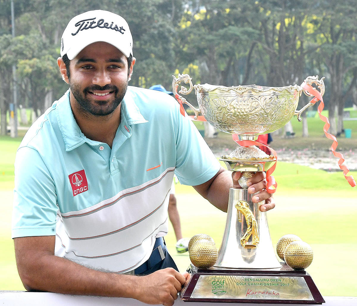 India's Abhinav Lohan with the Bengaluru Open golf championship trophy after winning the championship at KGA course in Bengaluru on Friday. Photo Srikanta Sharma R