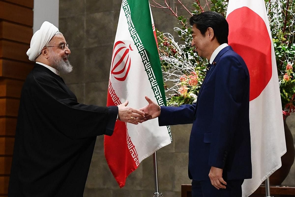 Hassan Rouhani and Japanese Prime Minister Shinzo Abe shake hands before their meeting at Tokyo, Japan. (AP Photo)