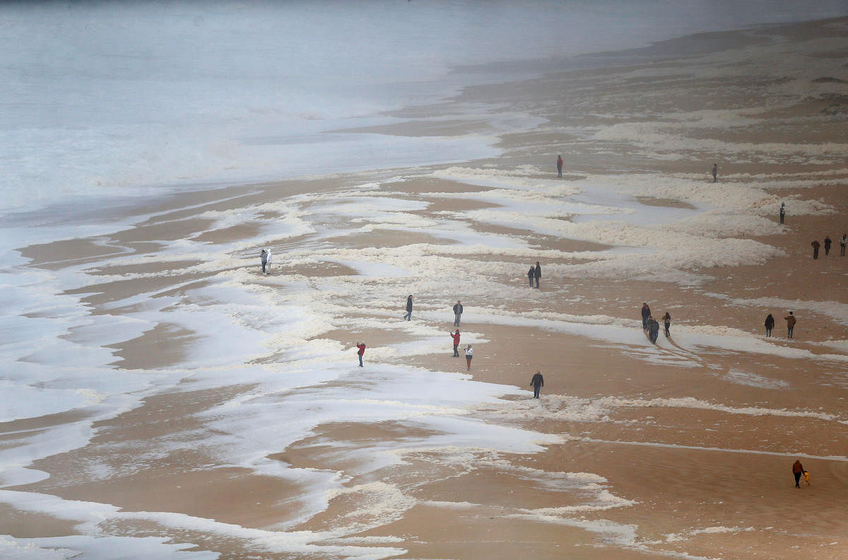 People gather to watch big waves at Praia do Norte in Nazare, Portugal. Reuters