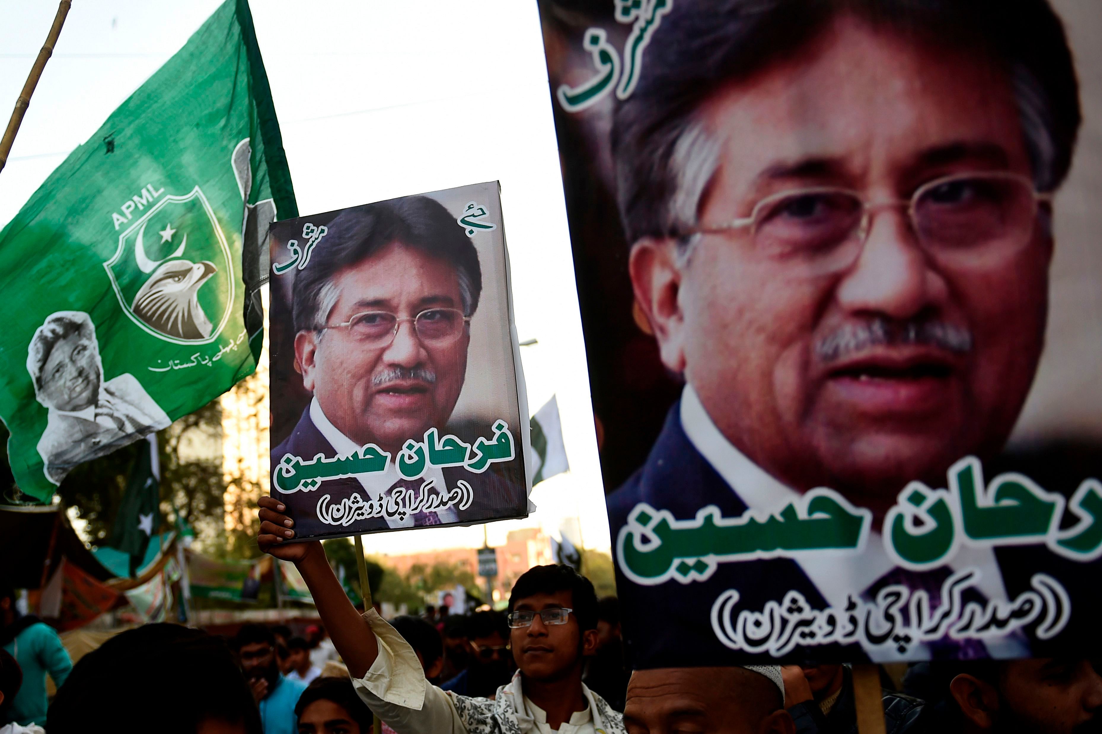 Demonstrators carry pictures of former military ruler Pervez Musharraf. (PTI Photo)