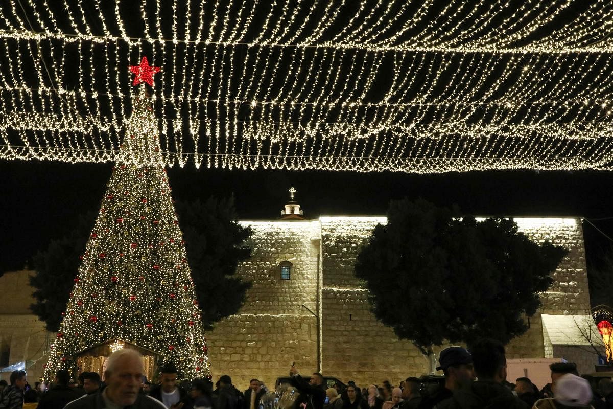Tourists and pilgrims visit the Manger Square outside the Church of the Nativity in the biblical West Bank city of Bethlehem on December 24, 2019. Photo/AFP