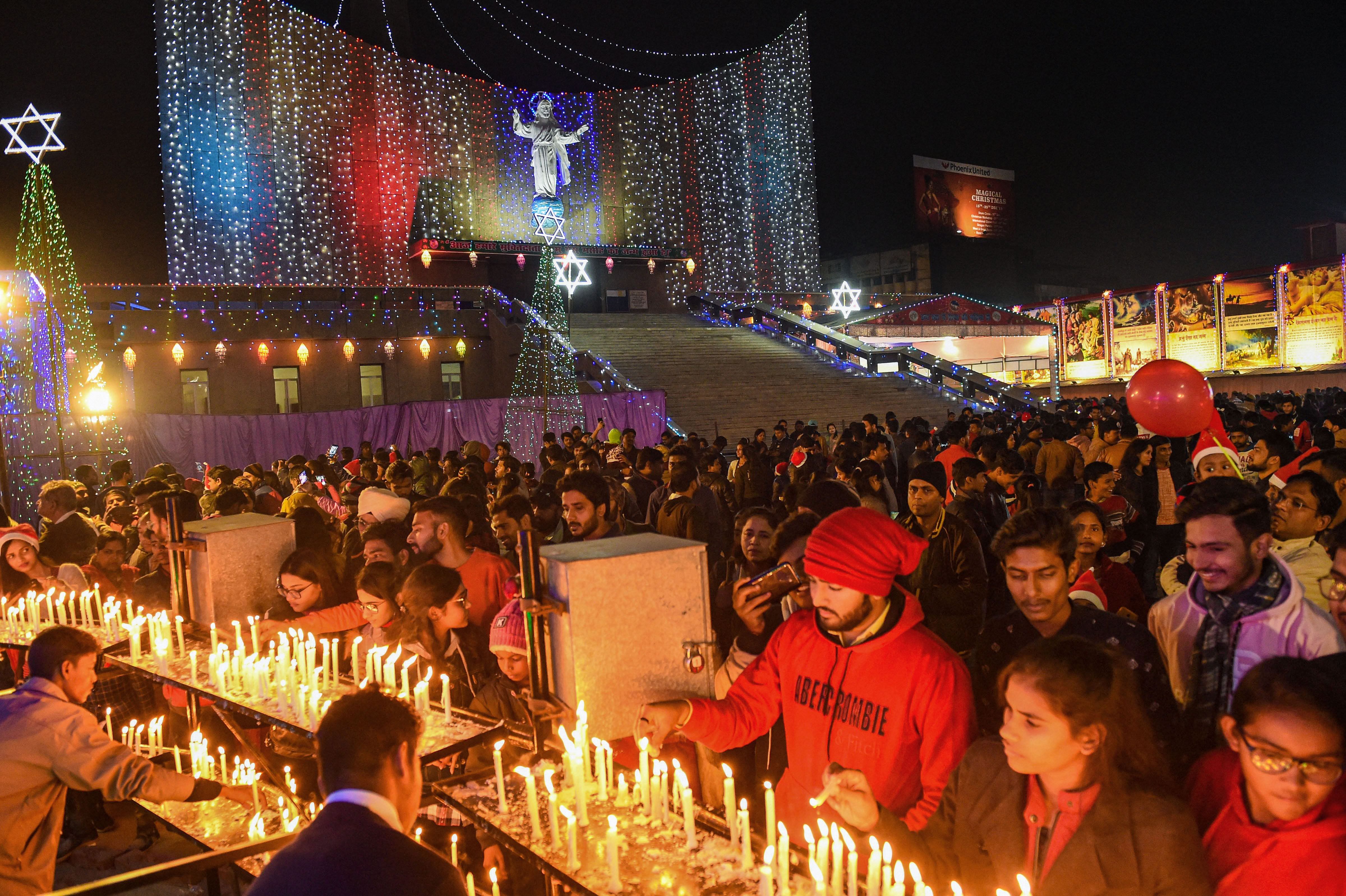  Devotees offer prayers at the St. Cathedral Church on the occasion of Christmas in Lucknow. (PTI Photo)