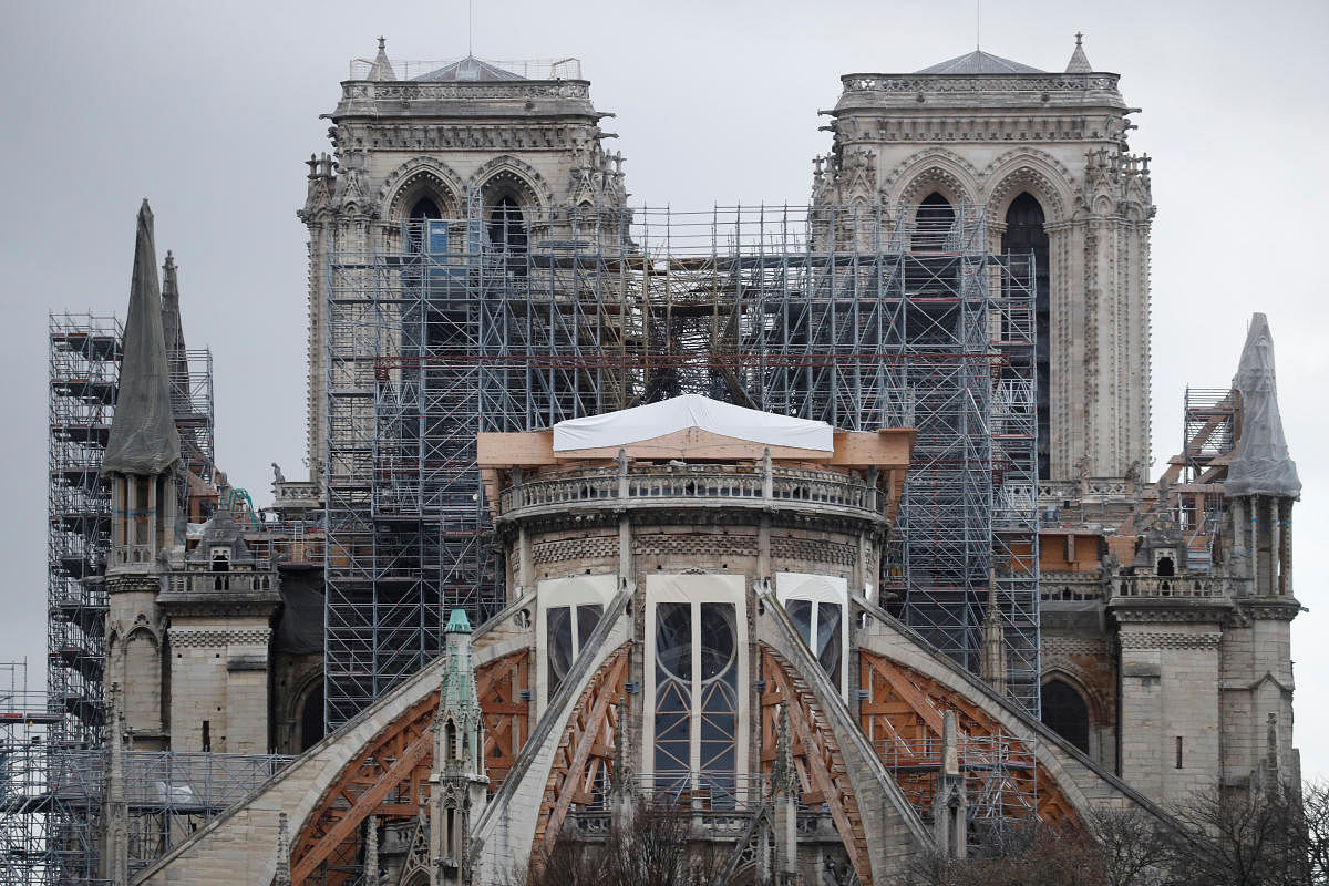 Meanwhile, workers continue to repair and rebuild the cherished cathedral. Photo/Reuters