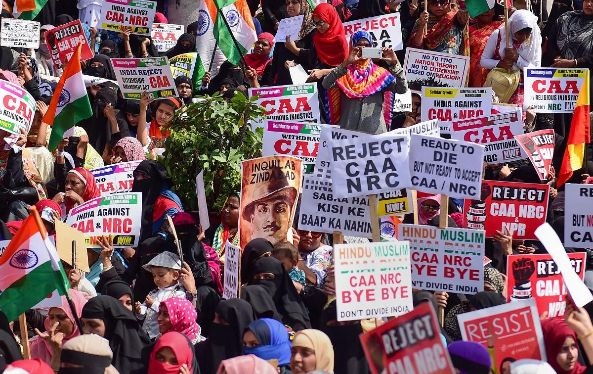 Members of Women India Movement display placards and raise slogans during a protest against the Citizenship Amendment Act (CAA), National Register of Citizenship (NRC) and National Population Register (NPR), in Bengaluru. PTI