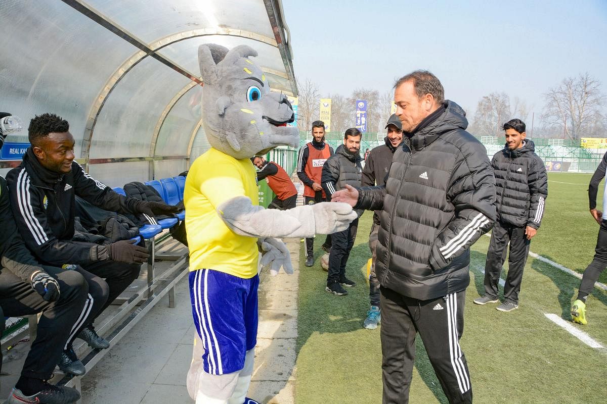Real Kashmir FC Head Coach David Robertson shakes hands with the mascot during a practice session ahead of their I-League 2019-20 match with Chennai City FC, in Srinagar, Wednesday, Dec. 25, 2019. Kashmir is all set to host first National level football match post-abrogration of Article 370 and bifurcation of the State. (PTI Photo)