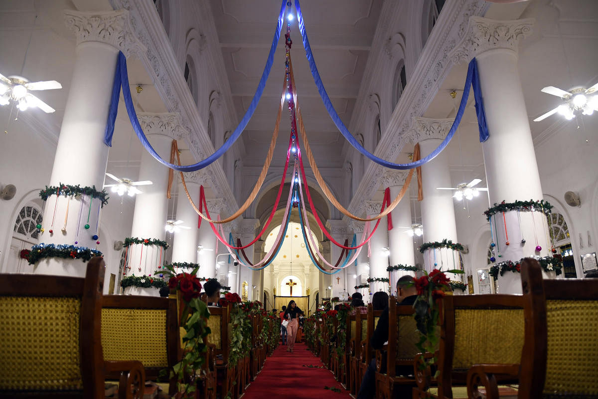 People gather at the St Mark's Cathedral during Christmas in Bengaluru on Wednesday. DH PHOTO/Pushkar V