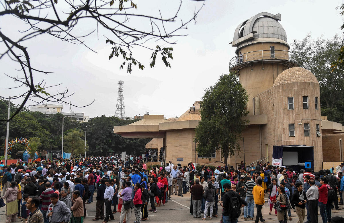 People gather to watch the annular solar eclipse at Jawaharlal Nehru Planetarium (JNP) in Bengaluru on Thursday. Photo/ B H Shivakumar