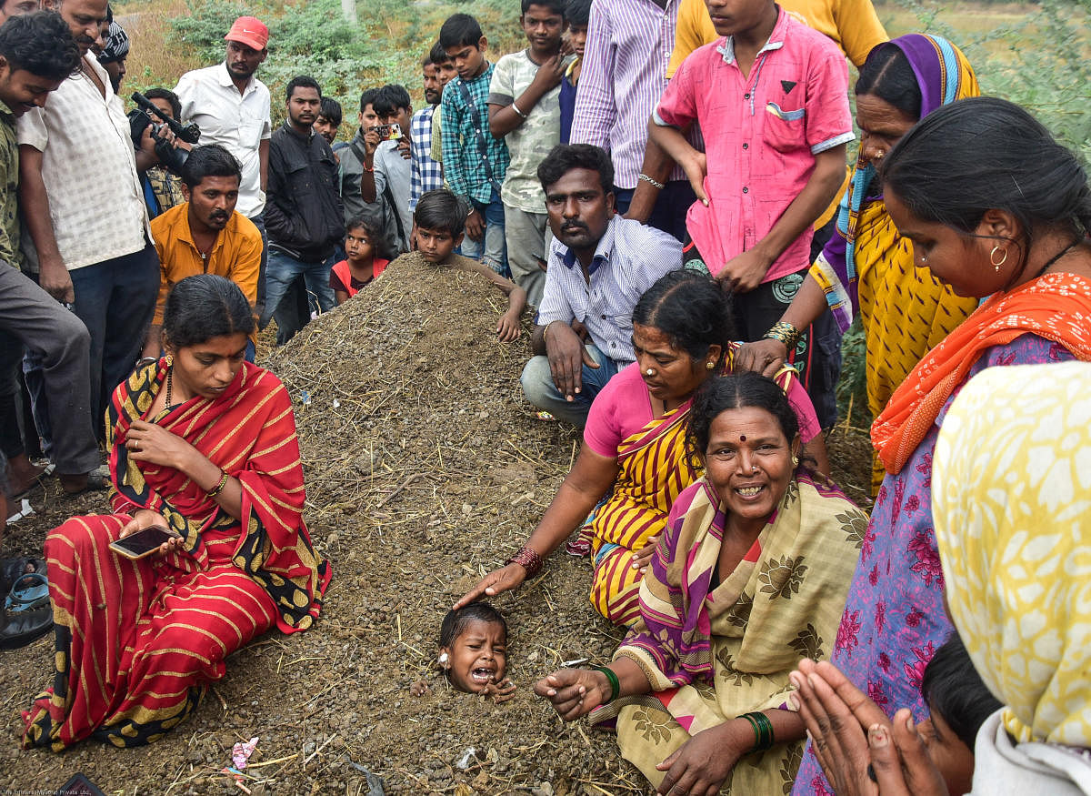 Two girls, aged 4 and 6, were buried neck-deep in the dirt, as part of a superstitious belief that the 'inhuman' practice observed during the solar eclipse would cure their ailments, at Tajsultanpur in Kalaburagi district. DH PHOTO