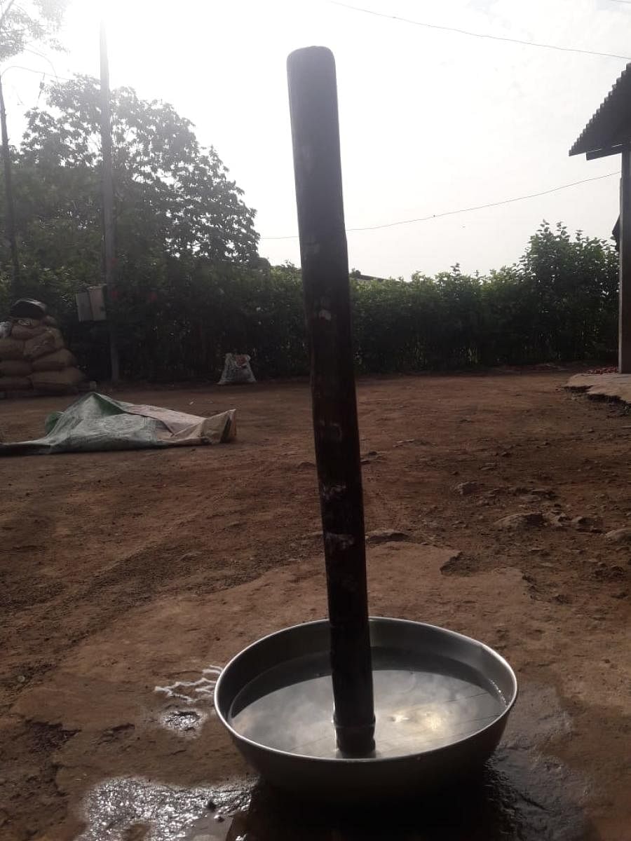 A pestle (pounding stick) in a water-filled copper vessel at Mugulkhod in Raibag taluk, Belagavi district. As per the belief, the pestle will stand intact through the eclipse hours and fall off on its own after the eclipse.