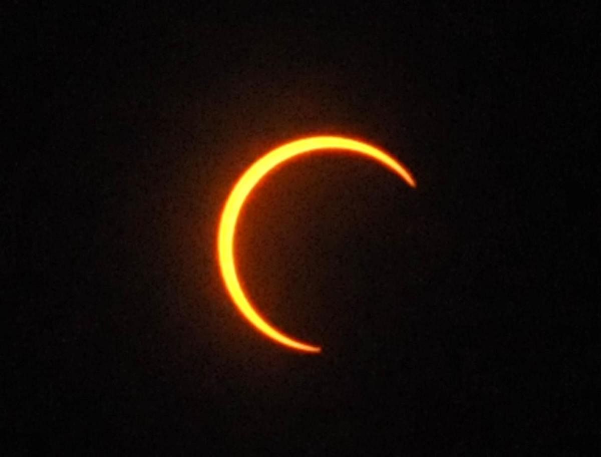 The sun takes the shape of a crescent moon during the eclipse seen in Chikkamagaluru on Thursday.