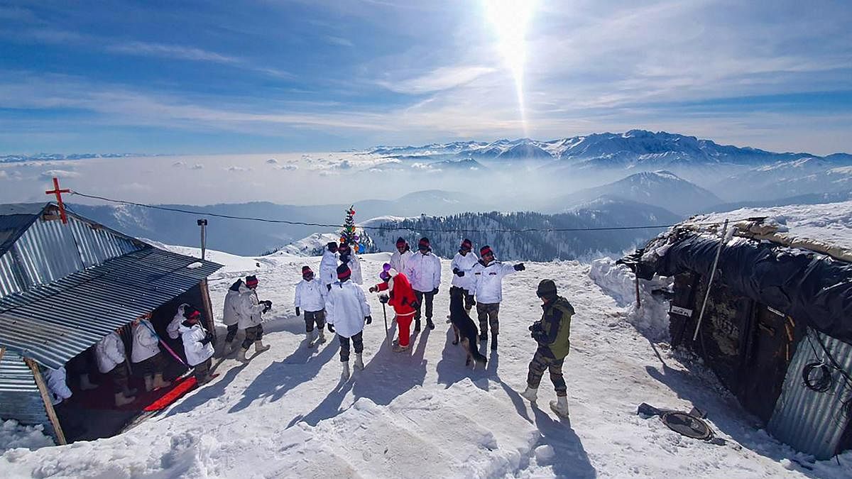 Army jawans celebrate Christmas outside their camps at a snow-covered mountain in north Kashmir, Wednesday, Dec. 25, 2019. (PTI Photo)