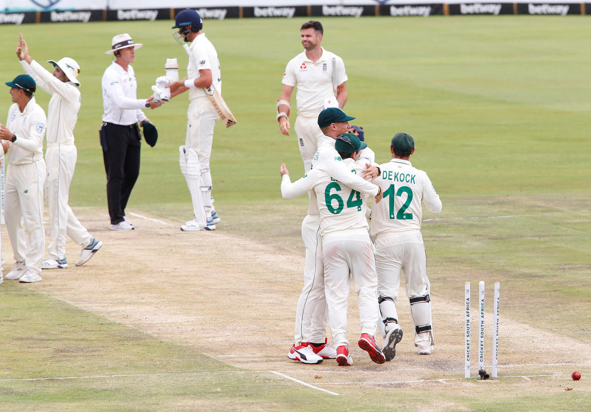  South Africa' Quinton de Kock celebrates winning the test match with teammates as England's James Anderson looks dejected. Reuters