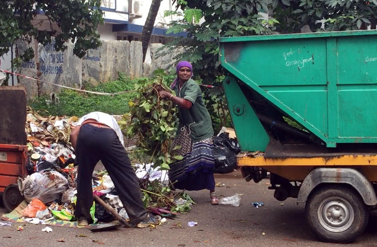 Pourakarmika collects waste at Indiranagar in Bengaluru.