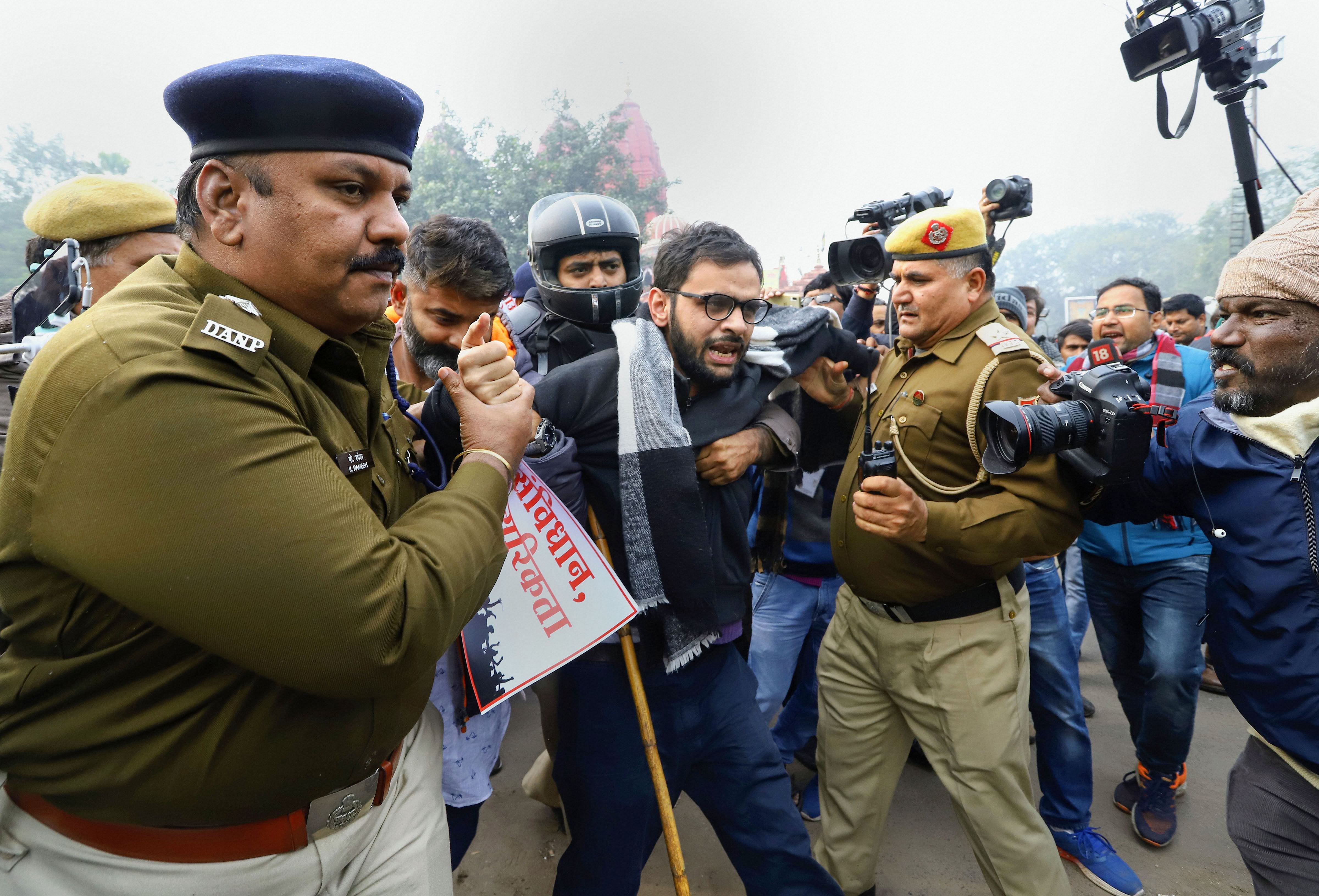 Former JNU student and activist Umar Khalid is detained by police for defying prohibitory orders imposed by the Delhi Police in the area during an anti-Citizenship Act protest, at Red Fort, in New Delhi. (PTI Photo)