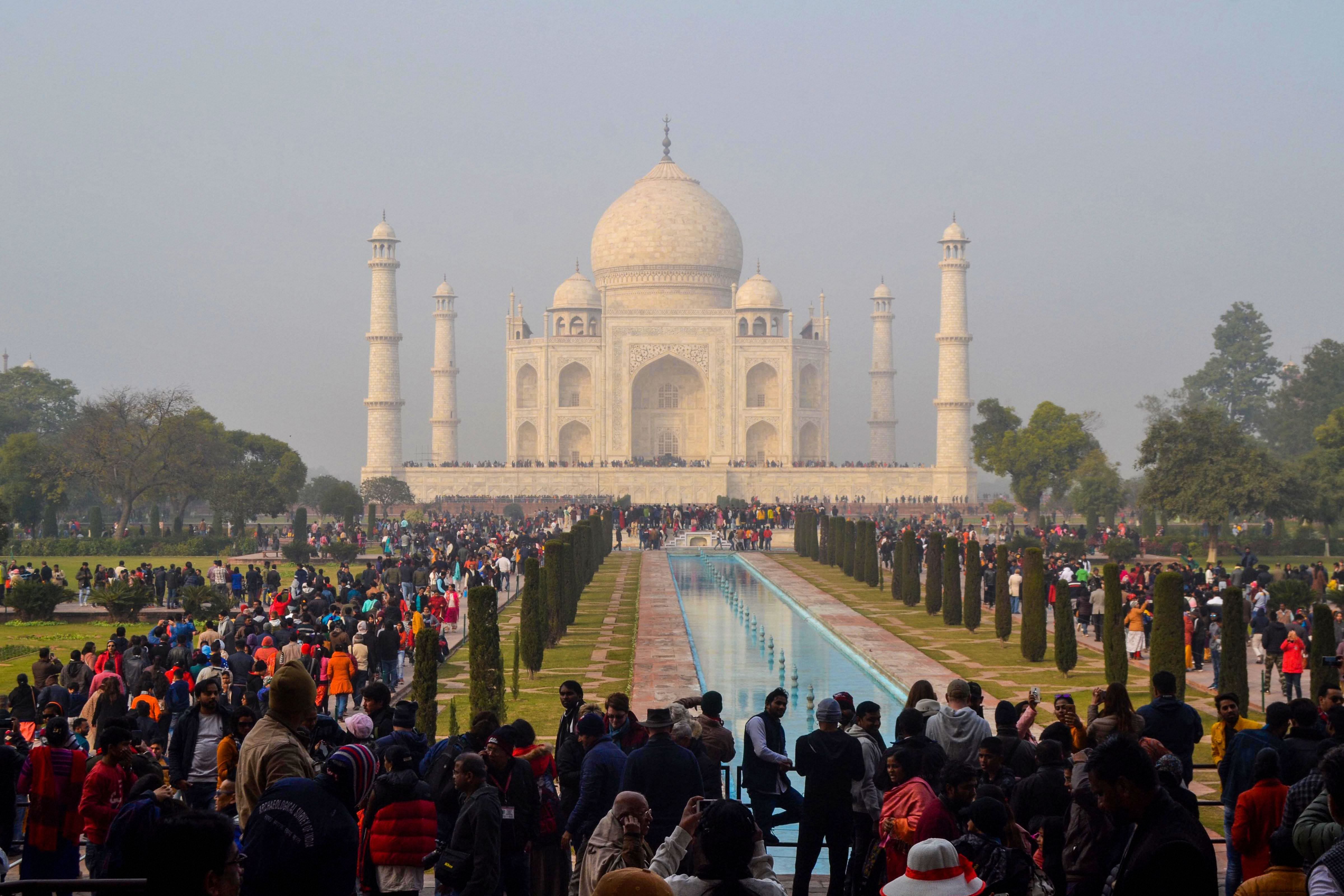 Tourists visit the historic Taj Mahal on a cold and wintry day in Agra. (PTI Photo)