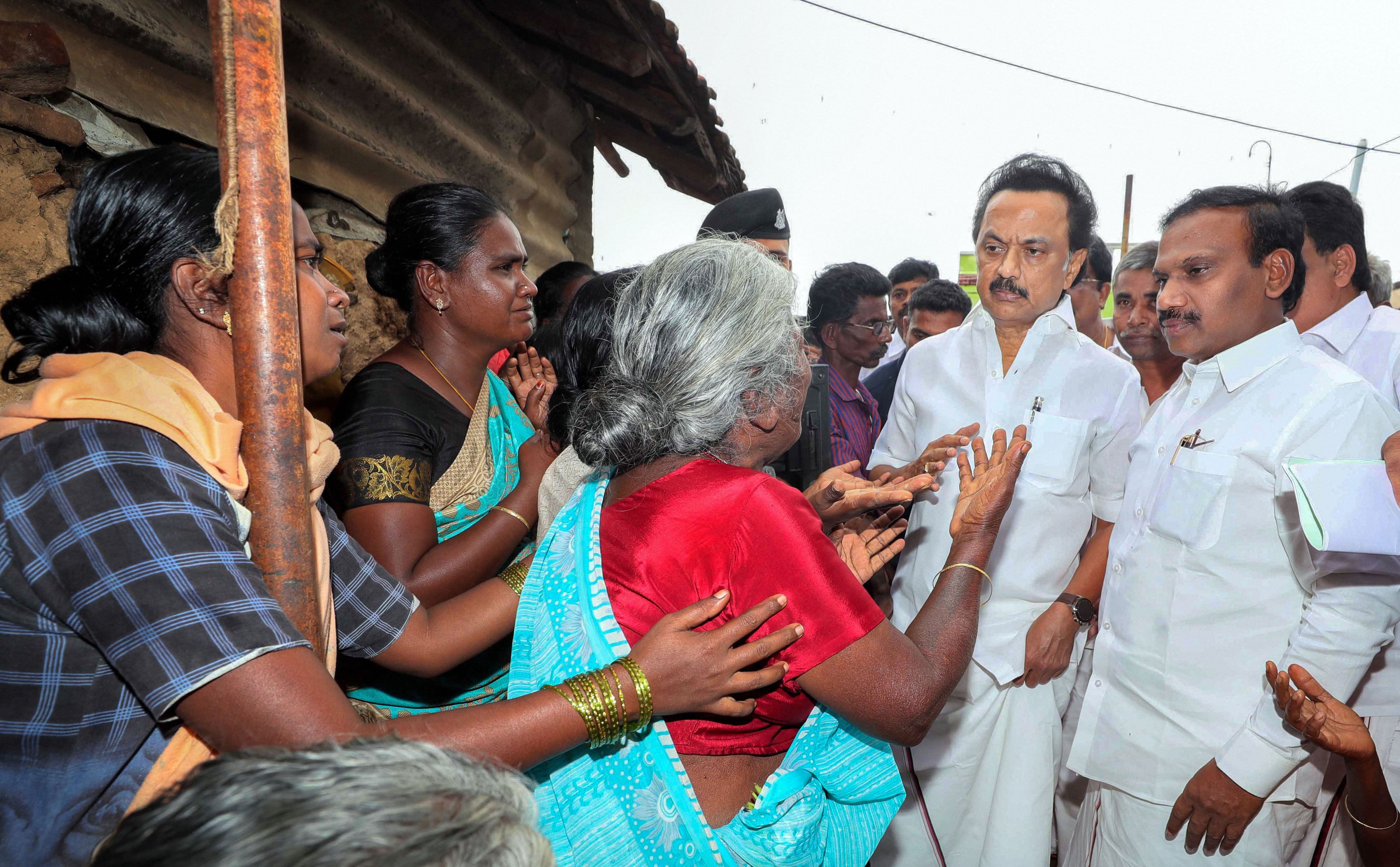 DMK Leader MK Stalin with Nilgiri MP A Raja consoles people at the site of the wall collapse in Nadur village of Mettupalayam taluk, near Coimbatore, Tuesday, Dec. 3, 2019. 17 people were killed in the incident after the compound wall of three tile roofed houses collapsed on them. (PTI Photo)