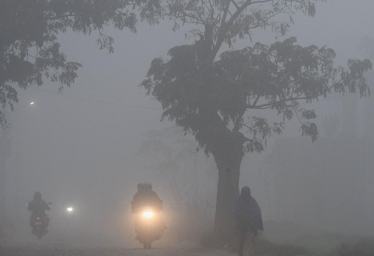 People commute through dense fog, near Mohali,(PTI Photo)
