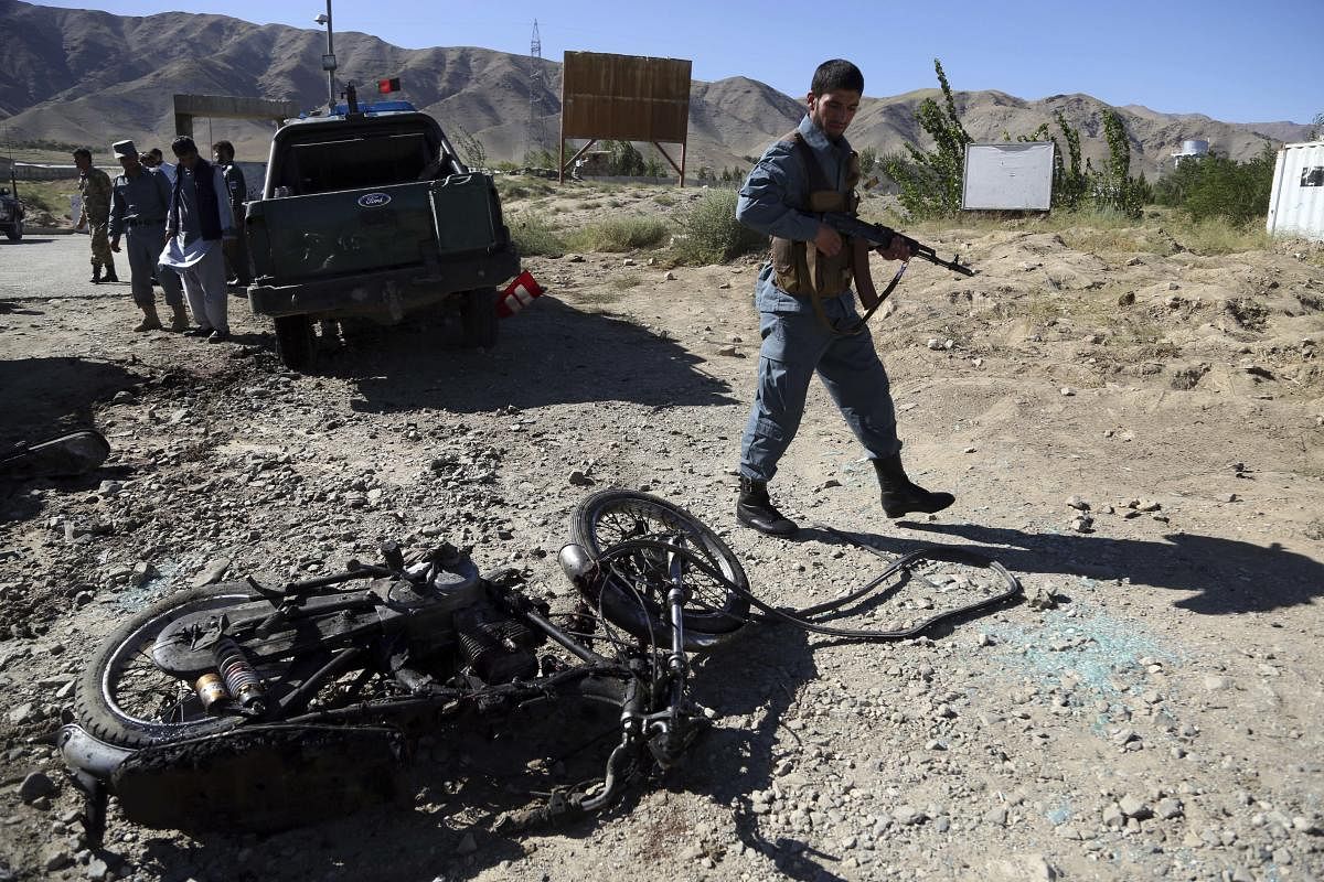 Afghan police inspect the site of a suicide attack, in northern Parwan province, Afghanistan, Tuesday, Sept. 17, 2019. (AP Photo)