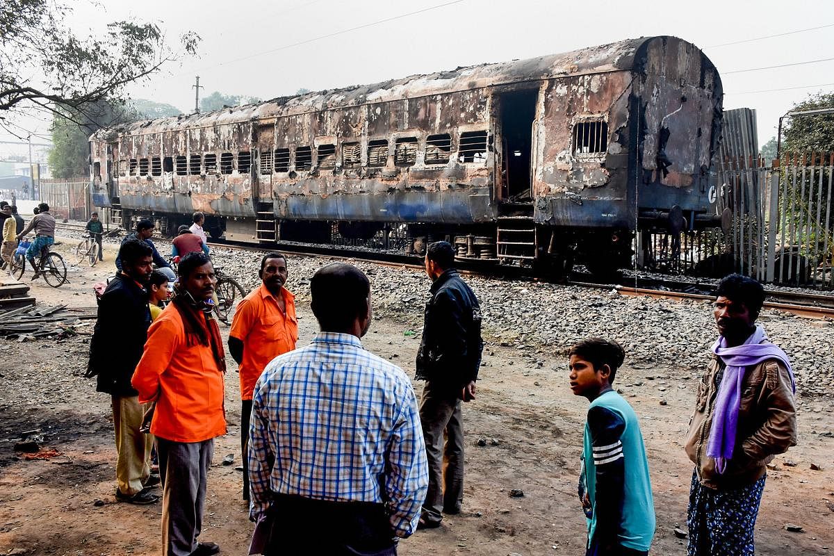 Murshidabad: Charred remains of a train coach that was set on fire on Friday by protestors during their agitation against NRC and CAB, at Beldanga Station in Murshidabad district of West Bengal, Saturday, Dec. 14, 2019. (PTI Photo)