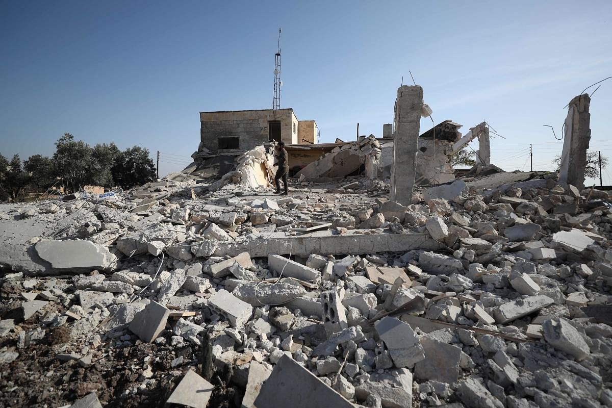 A Syrian man checks the damage outside a destroyed house following an air strike by pro-regime forces in the village of Sheikh Ahmad, on the Damascus-Aleppo Highway in the rebel-held northern Syrian province of Aleppo, on December 30, 2019. (Photo by AFP)