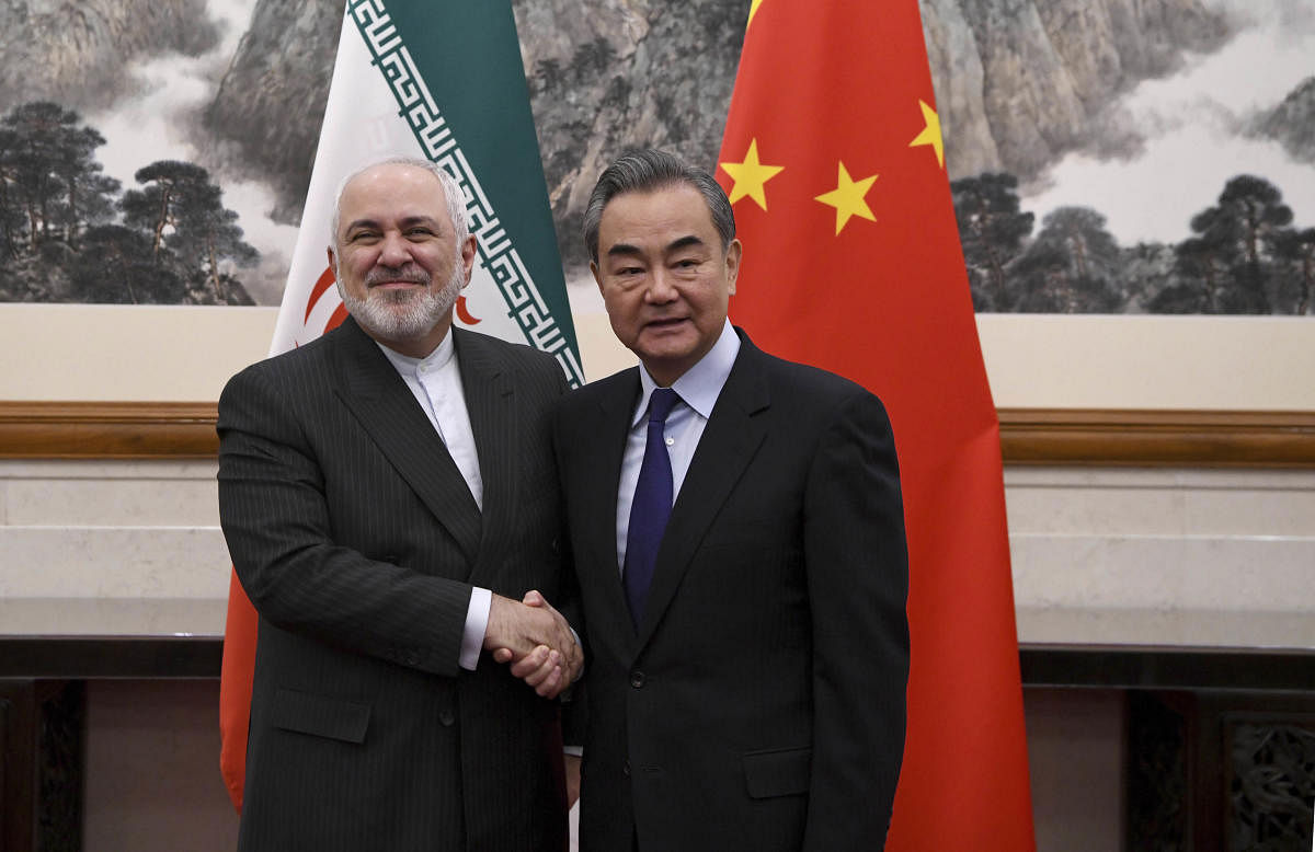 China's Foreign Minister Wang Yi, right, shakes hands with Iran's Foreign Minister Mohammad Javad Zarif. (AP/PTI photo)