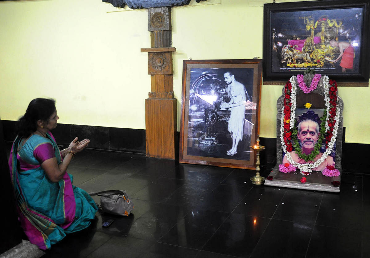 A devotee pays obeisance in front of the portrait of seer Vishwesha Theertha Swami at Pejawar Mutt in Udupi on Monday.