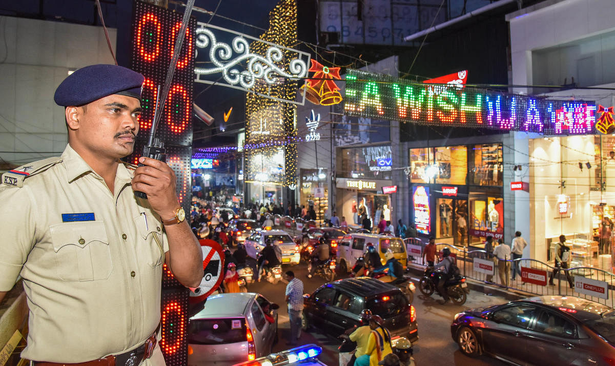 A police officer stationed at Brigade Road ahead of New Year's Eve celebrations on Monday. DH PHOTO/S K DINESH