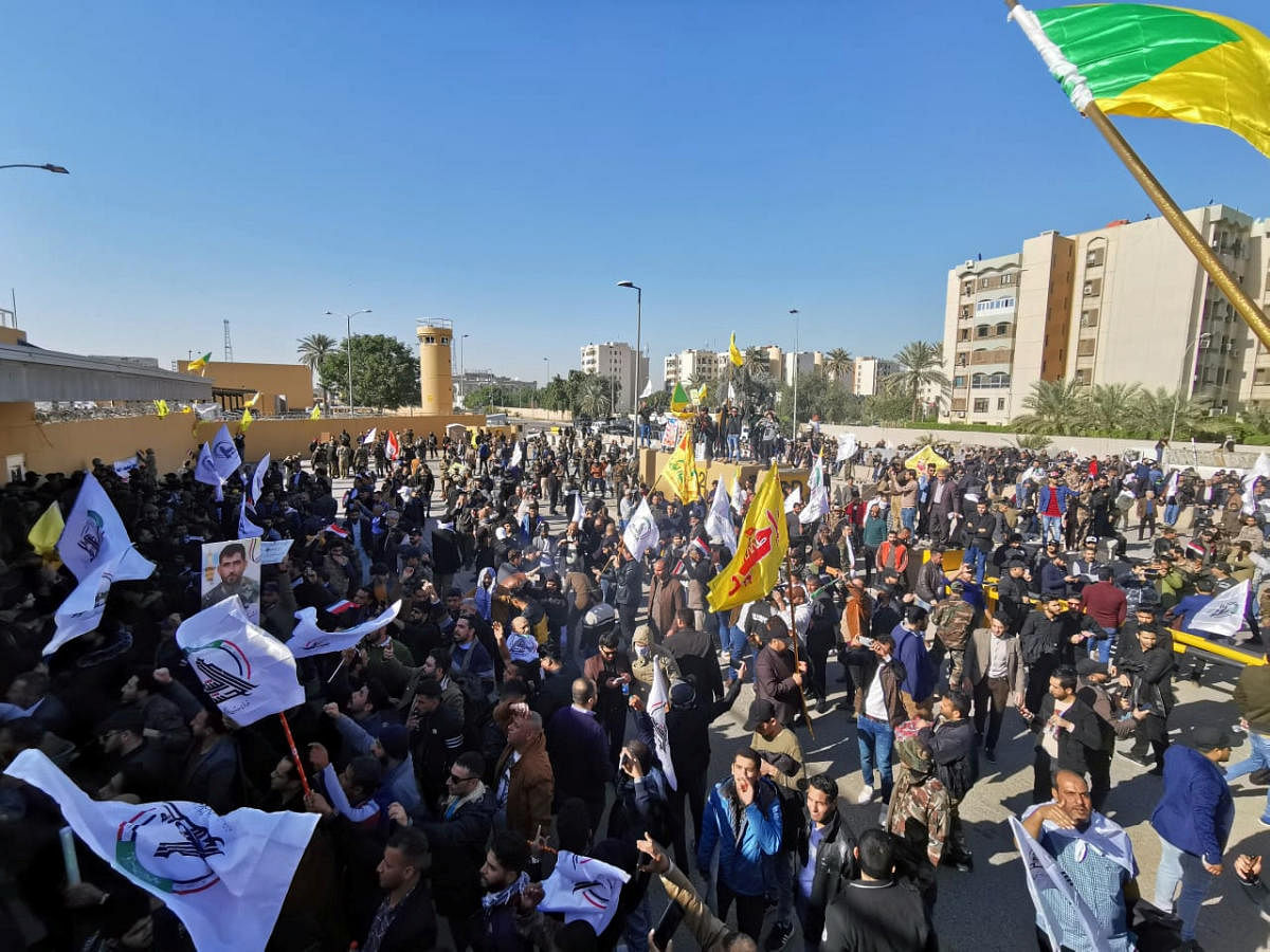 Protesters and militia fighters gather to condemn air strikes on bases belonging to Hashd al-Shaabi (paramilitary forces), outside the main gate of the U.S. Embassy in Baghdad, Iraq December 31, 2019. (Reuters Photo)