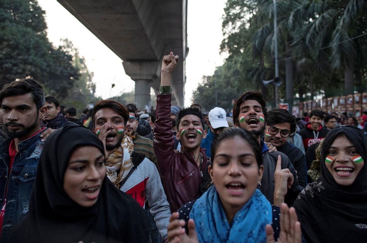Demonstrators attend a protest against a new citizenship law, outside the Jamia Millia Islamia university in New Delhi. Reuters
