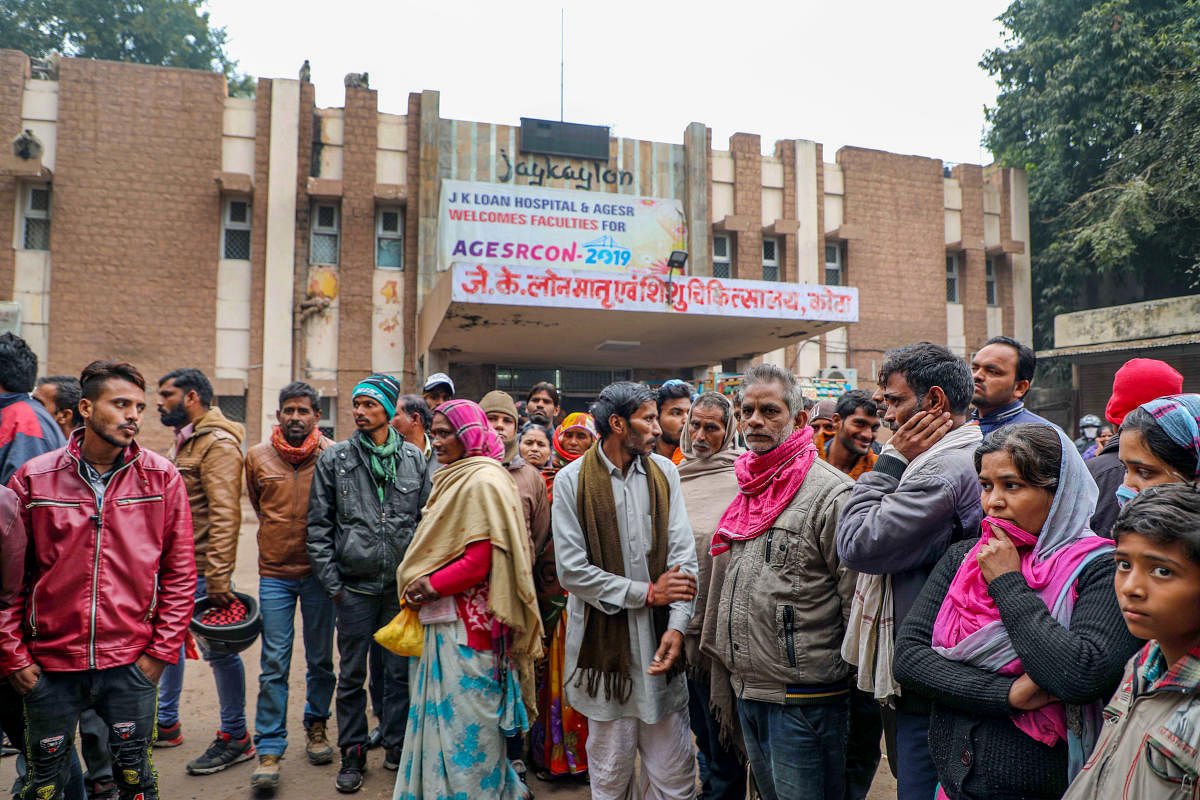  Family members and relatives of their infant children wait outside the JK Lone hospital, in Kota district. (PTI Photo)