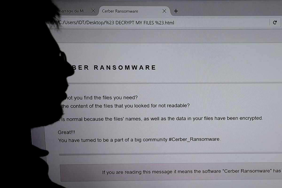 In this file photo taken on November 03, 2016 an IT researchers stands next to a giant screen a computer infected by a ransomware at the LHS (High Security Laboratory) of the INRIA (National Institute for Research in Computer Science and Automation) in Re