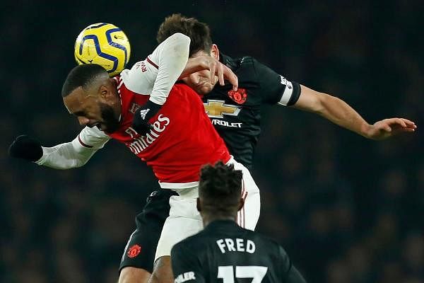 Arsenal's French striker Alexandre Lacazette (L) vies with Manchester United's English defender Harry Maguire (R) during the English Premier League football match between Arsenal and Manchester United at the Emirates Stadium in London on January 1, 2020. (AFP Photo)