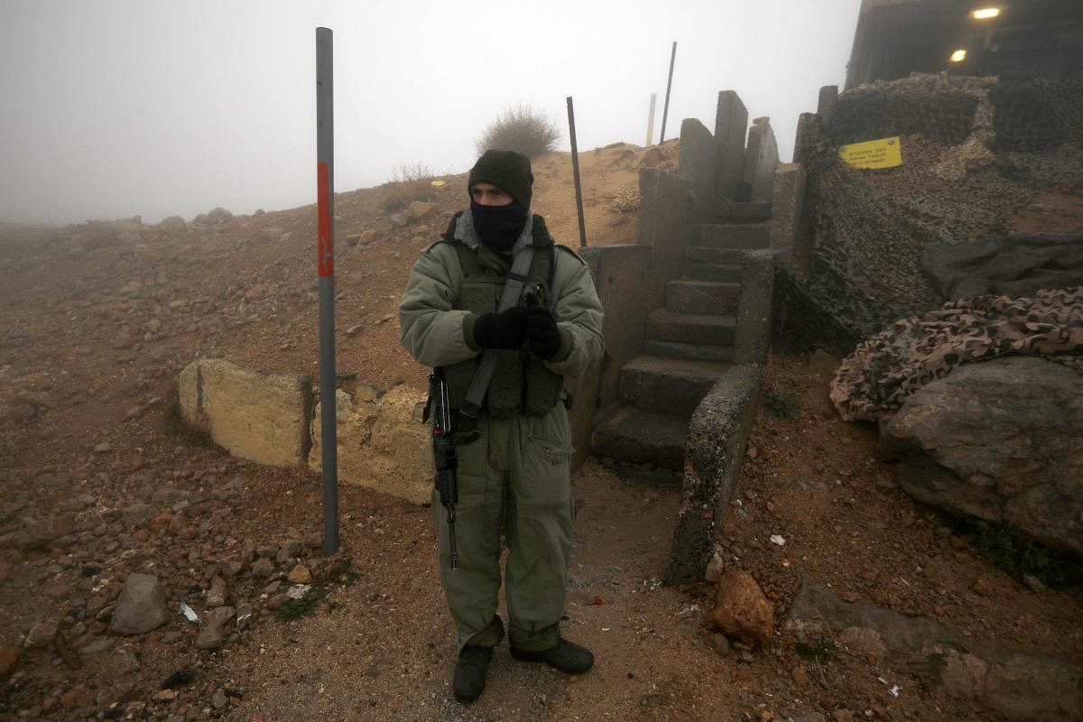 An Israeli soldier based in a military zone in a ski resort patrols an area in Mount Hermon in the Israeli-annexed Golan Heights from the Syrian side. (AFP Photo)