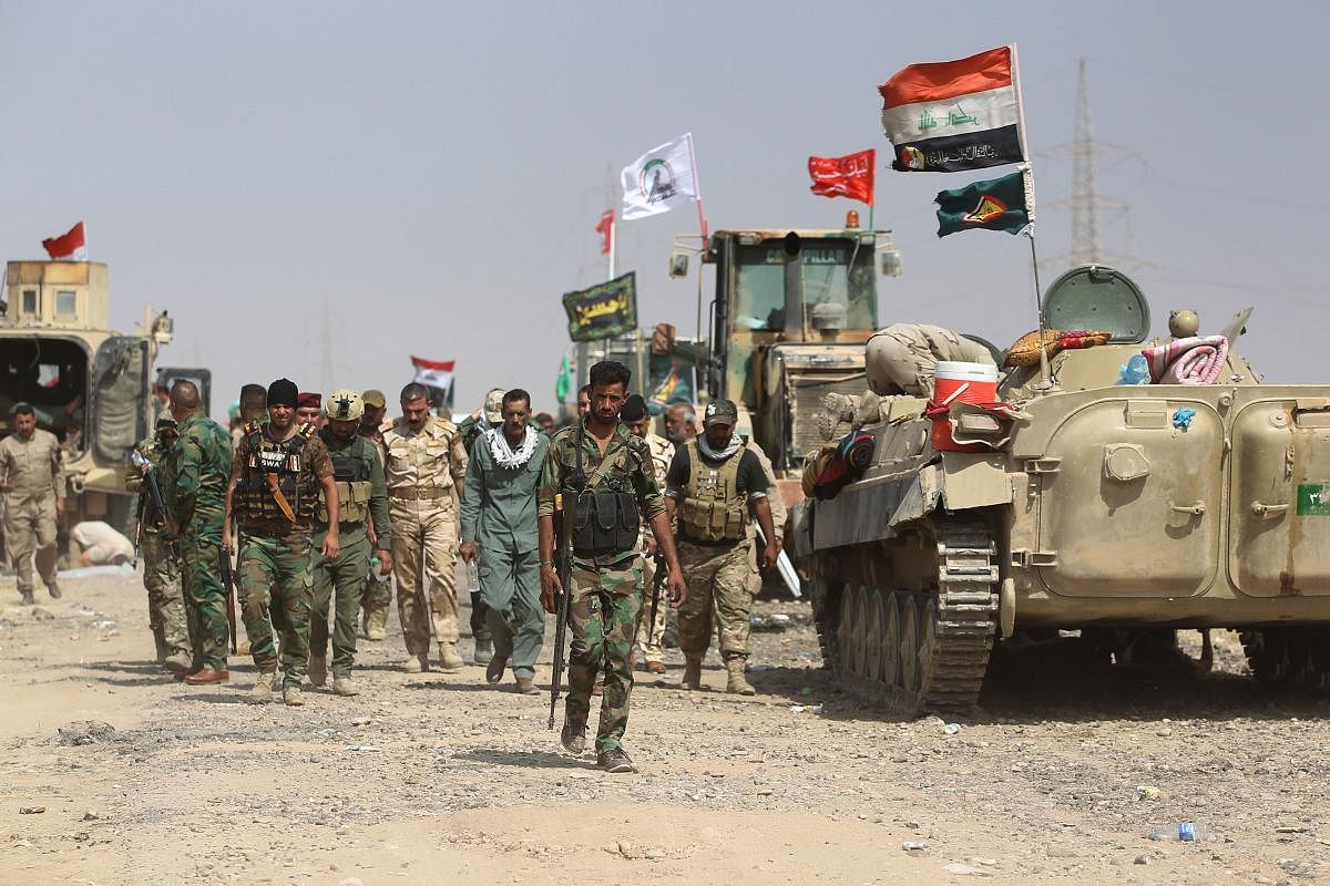 "It's not a halt," the source said, adding: "We have increased security and defensive measures at Iraqi bases that host coalition troops." (Photo by AFP)