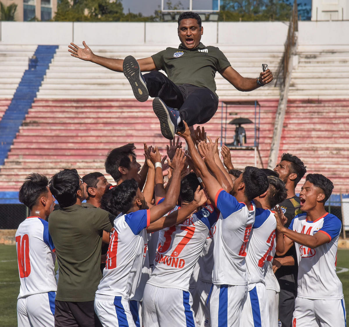 Bengaluru FC players celebrate their second straight BDFA Super Division League triumph by lifting coach Naushad Moosa in the air on Saturday. DH PHOTO/ SK Dinesh