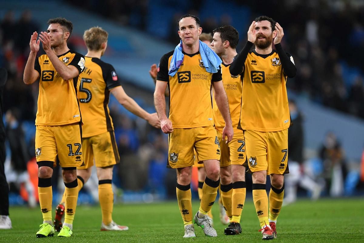 Port Vale's players applaud supporters on the pitch after the English FA Cup third round football match between Manchester City and Port Vale at the Etihad Stadium in Manchester, north west England, on January 4, 2020. (AFP Photo)