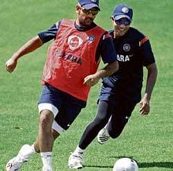 gearing up: Indian skipper M S Dhoni (left) and Ravindra Jadeja play soccer during a training session in Winwards, Barbados on Wednesday.