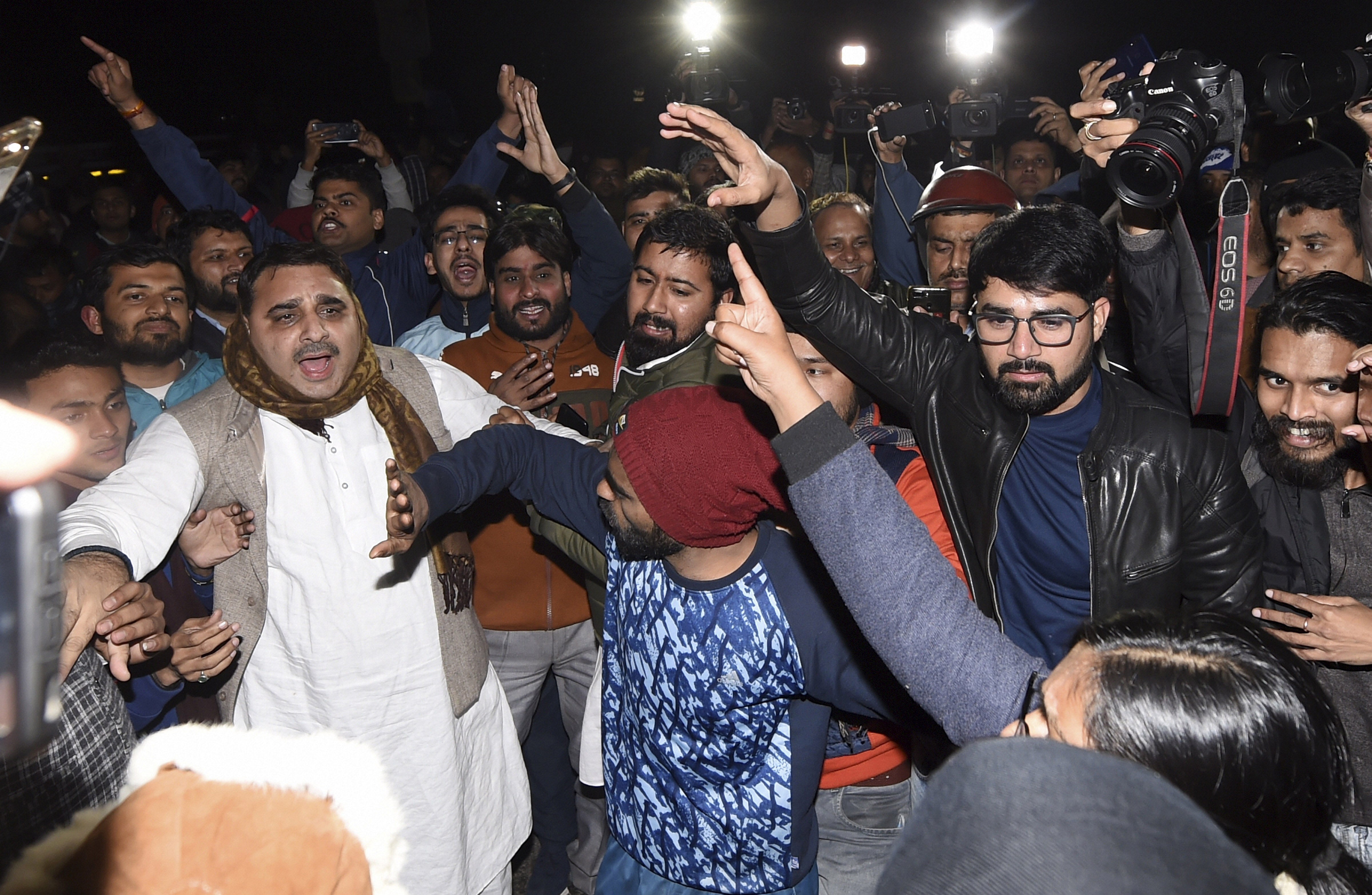 Students and other people shouting slogans at out side of the JNU campus. (PTI Photo)