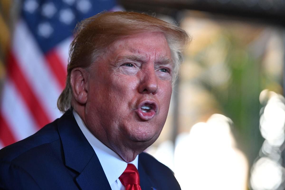 In this file photo taken on December 24, 2019 US President Donald Trump answers questions from reporters after making a video call to the troops stationed worldwide at the Mar-a-Lago estate in Palm Beach Florida. (AFP Photo)