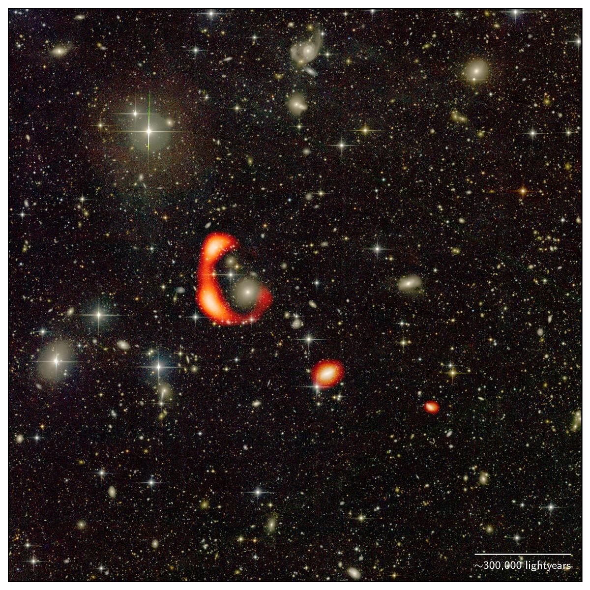 The large red-coloured ring is the giant hydrogen ring discovered using GMRT. The other two red blobs distribution of hydrogen around two other galaxies in the vicinity of the ring.