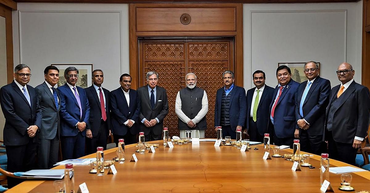 Prime Minister Narendra Modi poses for a group photo with Reliance Industries chairman Mukesh Ambani, Tata Group patriarch Ratan Tata, Business tycoon Anand Mahindra and others during an interaction with leading business stalwarts to discuss ways to improve growth and job creation, in New Delhi. PTI