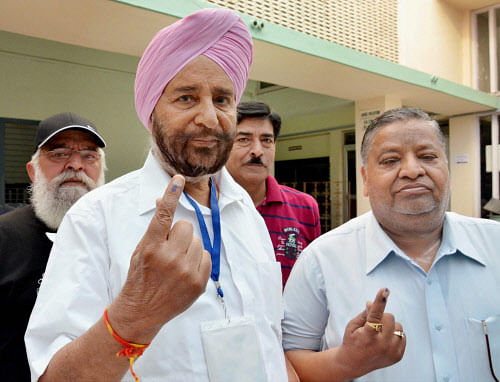 AAP candidate from Amritsar Daljit Singh shows his inked finger after casting vote for Lok Sabha election in Amritsar on Wednesday. PTI Photo