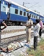 Death On Track: Police clearing a body which was found on the railway track at Malleswaram on Wednesday. DH Photo