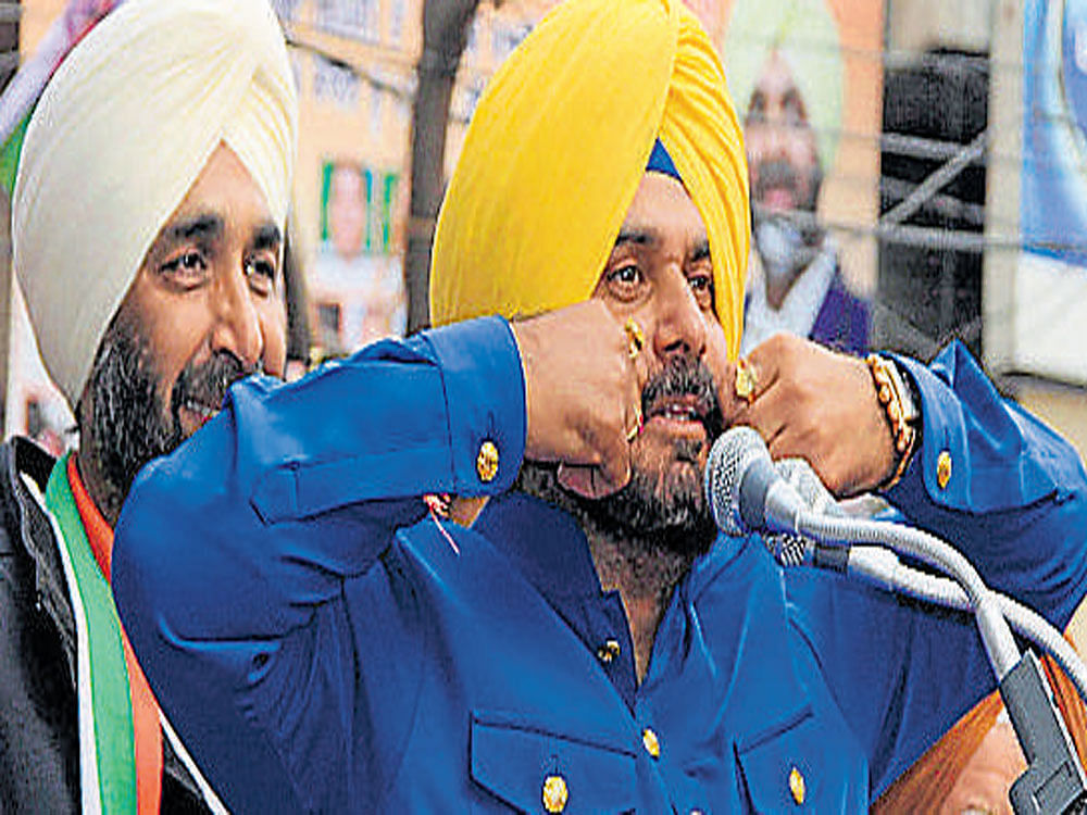 Congress leader Navjot Singh Sidhu addresses an election rally in support of party candidate Manpreet Singh Badal in Bathinda on Thursday. PTI