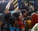 Passengers struggle to enter the Patna bound Sampurn Kranti Express train at the New Delhi Railway Station in New Delhi on Sunday. AP